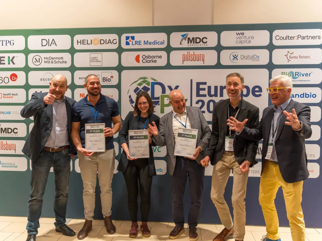 DxPx Europe 2026 pitch-award recipients and participants standing in front of the event wall.
Image credit: Courtesy of DxPx Conferences (SLS Partnering GmbH).